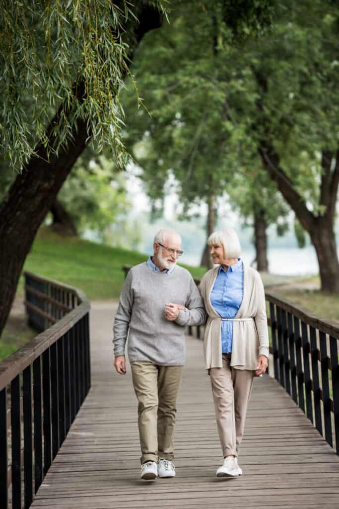 nice senior couple enjoying walking in park